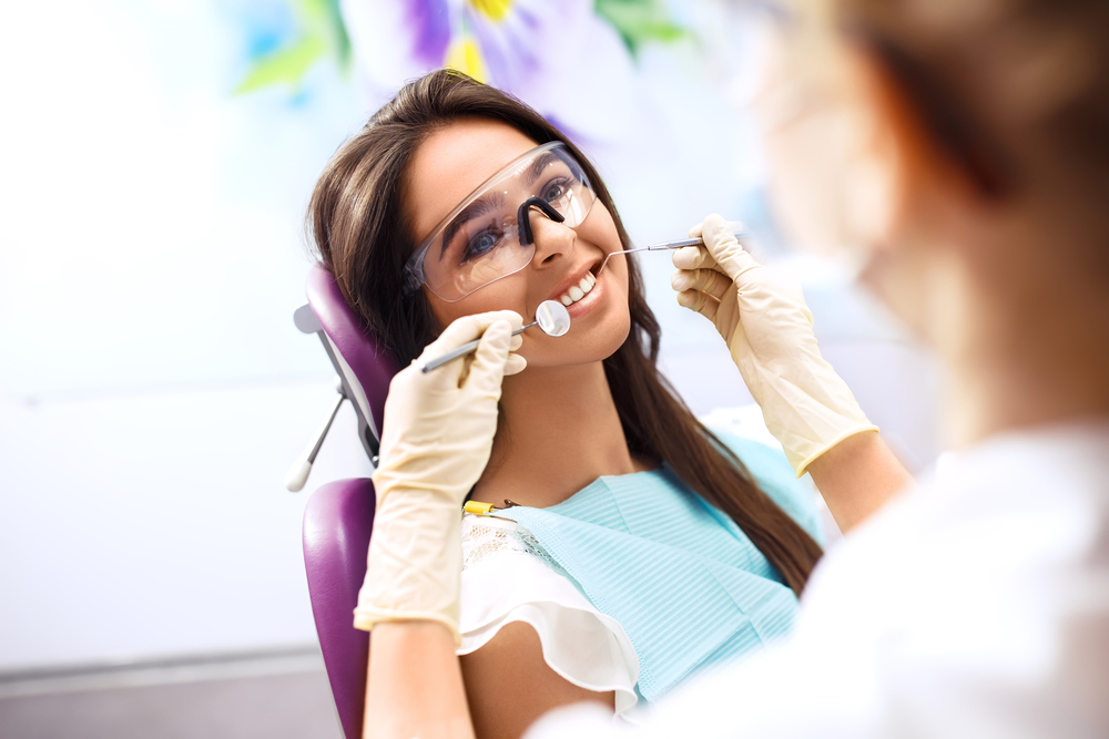 Woman Getting A Dental Exam and Cleaning